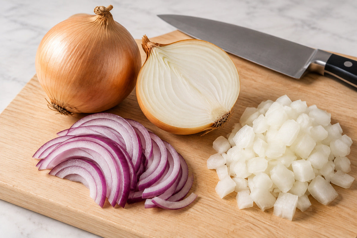 Whole, halved, sliced and chopped onions on a wooden cutting board