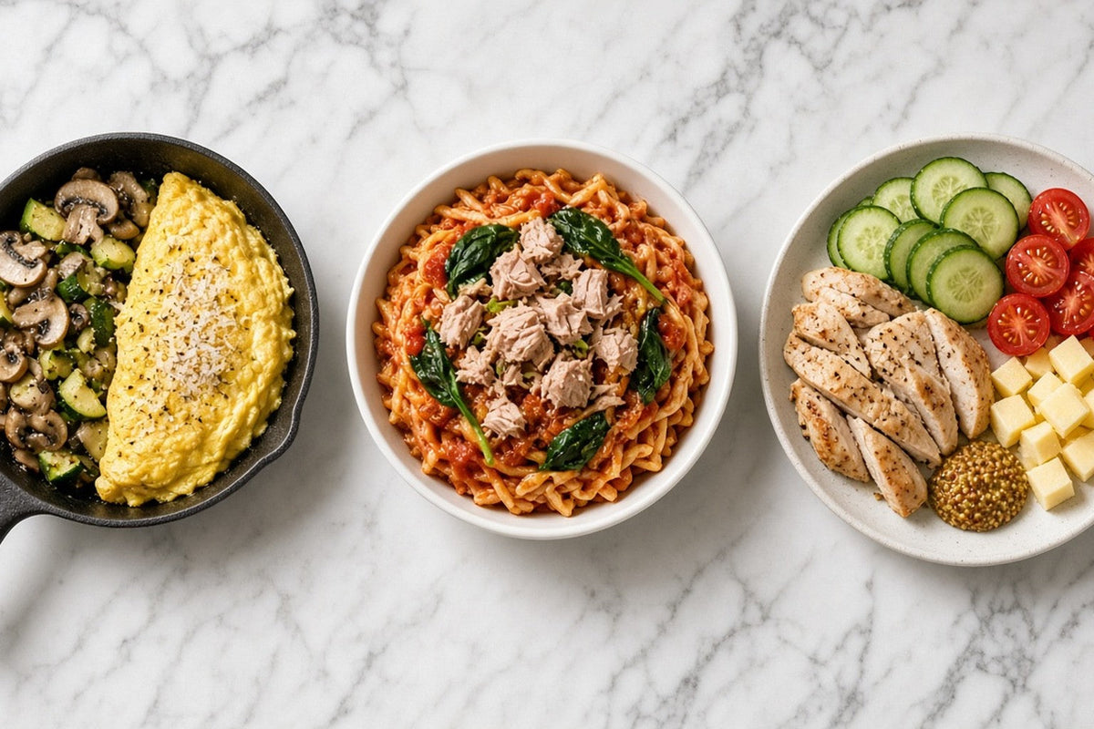 Three backup dinners in a row: a skillet of eggs with mushrooms and zucchini, a bowl of pasta with tuna and spinach, and a plate of sliced chicken with cucumber, tomato and cheese.