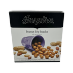 A purple cup spills peanut soy snacks onto a white surface, with whole peanuts scattered around, showcasing the product titled "Peanut Soy Snacks" by Inspire.