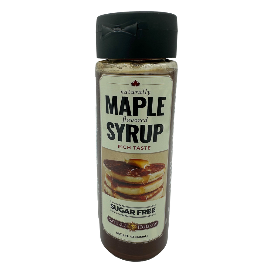 A clear bottle of sugar-free maple syrup features a label with bold text stating "naturally MAPLE flavored" and an image of pancakes drizzled with syrup, indicating its rich taste.