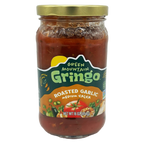 A clear glass jar of Green Mountain Gringo roasted garlic medium salsa, featuring a colorful label with images of vegetables, sits against a plain background.