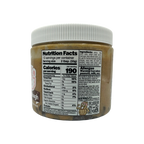A clear jar of edible cookie dough spread displays the nutrition facts label, including serving size, calories, and allergen warnings for peanuts, milk, and soy.