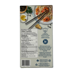 A nutrition facts label is displayed on the back of a food package, featuring details about calories, ingredients, and cooking instructions, alongside a plate of shrimp pasta and chopsticks.