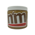 A close-up of a jar of "Nuts n More" nut butter, featuring a white lid and a label with bold brown and red text, set against a black background.