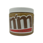 A close-up of a jar of "Nuts n More" nut butter, featuring a white lid and a label with bold brown and red text, set against a black background.