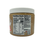 A jar of peanut butter with a white lid displays nutrition facts and ingredient information, highlighting allergens and serving size on a black background.