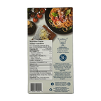 A nutrition facts label on a food package displays cooking instructions and nutritional information, alongside a plate of spaghetti topped with cheese and basil, and fresh tomatoes in the background.