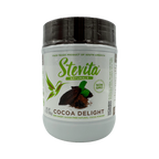 A white container of Stevita Naturals Cocoa Delight cocoa powder features a green logo, a hummingbird graphic, and labels indicating it's fair-trade, non-GMO, and sugar-free.