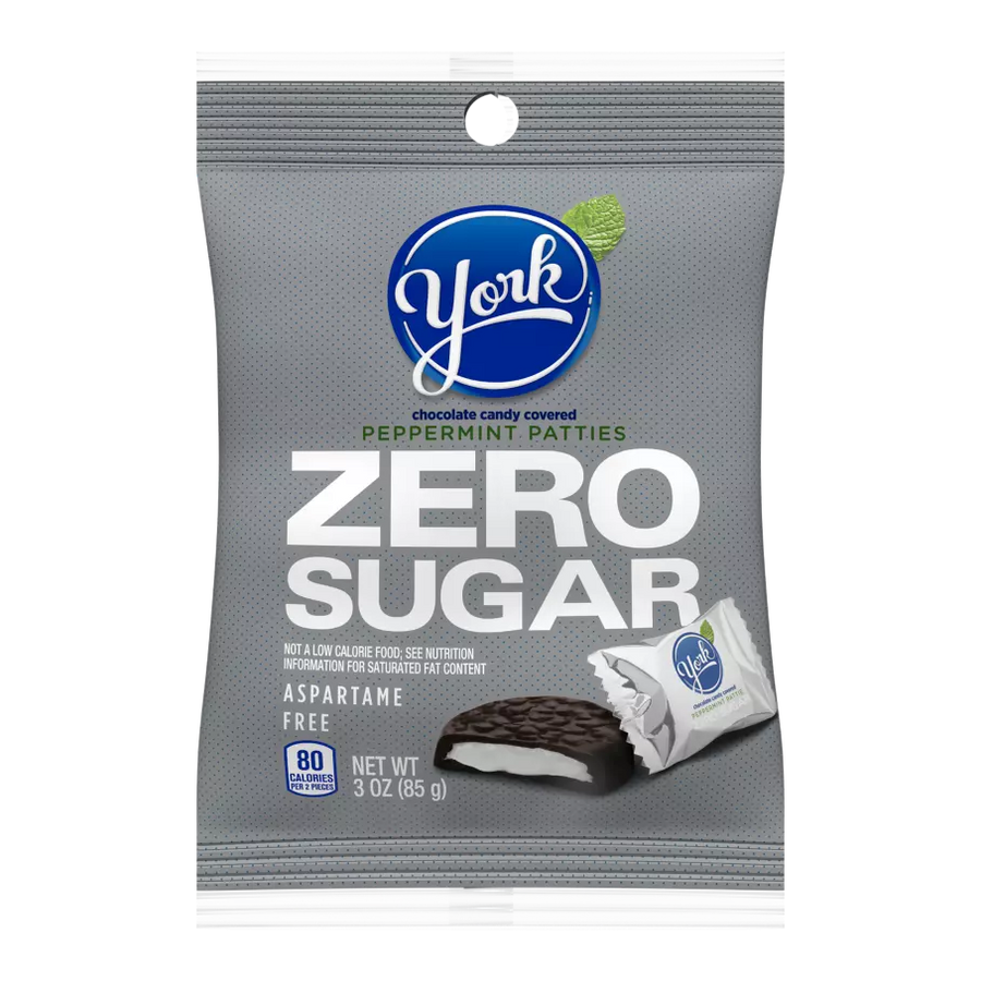 A gray bag of York Zero Sugar Peppermint Patties features the brand logo, highlights "ZERO SUGAR" prominently, and indicates it is aspartame-free, containing 80 calories per serving.
