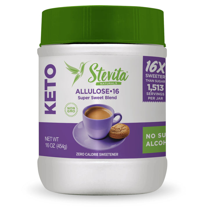 A white jar of Stevita Naturals Allulose sweetener features a green lid, purple accents, and an illustration of a coffee cup with a cookie, highlighting its keto-friendly and non-GMO attributes.