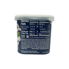 A plastic container displays nutrition facts for a non-dairy creamer, highlighting serving size, calories, and ingredients, with a dark background emphasizing the text.