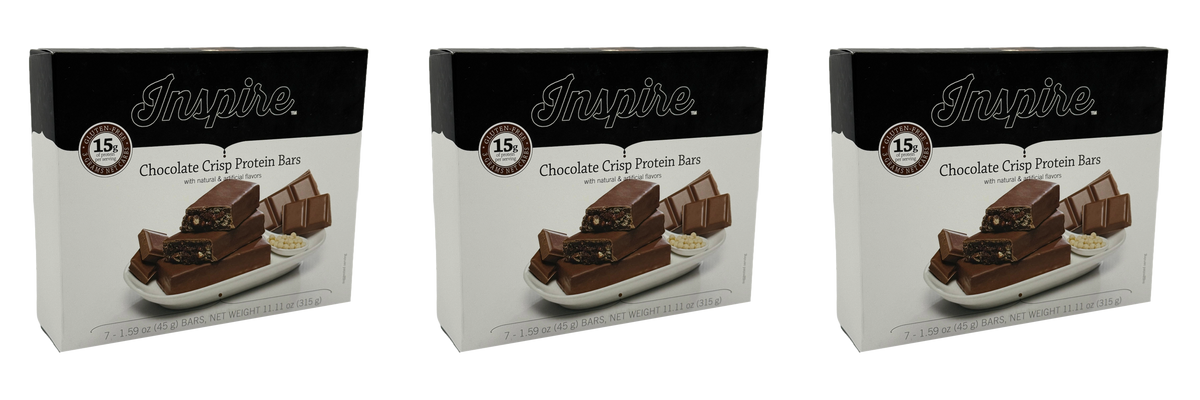 Three boxes of Inspire Chocolate Crisp Protein Bars are displayed, featuring bars on a plate, with text highlighting 15 grams of protein per serving and gluten-free labeling.