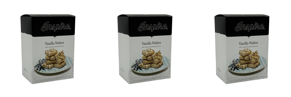 Three boxes of "Inspire Vanilla Wafers" are displayed, each featuring a stack of wafers on a blue plate, emphasizing the product's natural and artificial flavors.