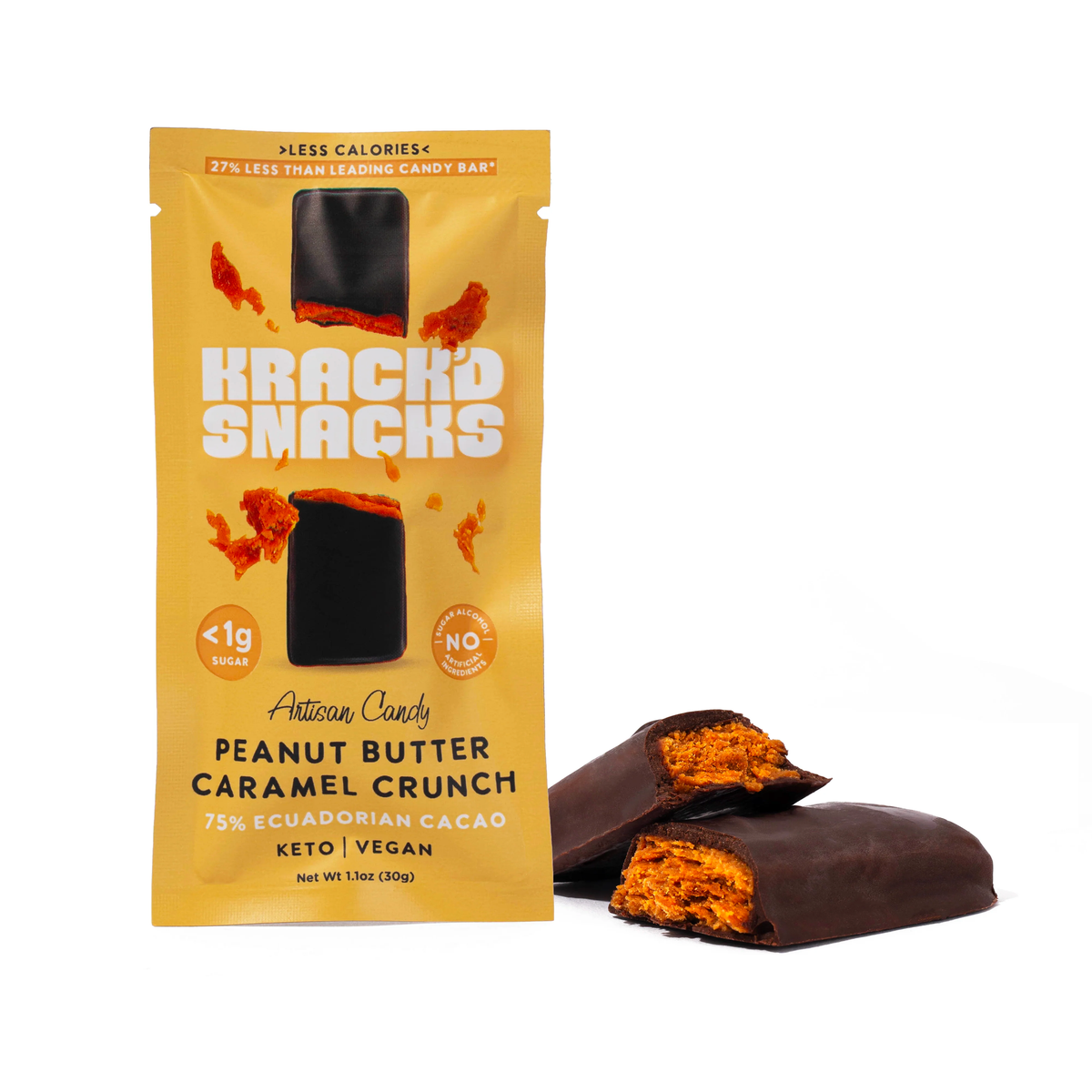 A package of Krack'd Snacks artisan candy featuring a peanut butter caramel crunch flavor stands upright, with a chocolate-covered candy bar partially cut open beside it, revealing its orange filling.