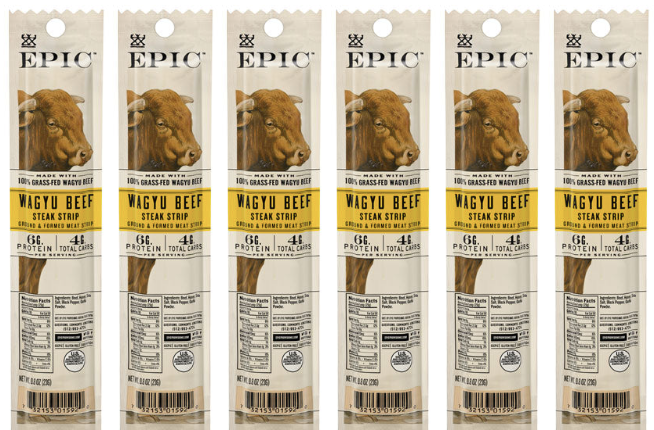 Six packages of EPIC Wagyu Beef Steak Strips are displayed in a row, each featuring a brown cow's head on the label, highlighting its grass-fed ingredients and protein content.