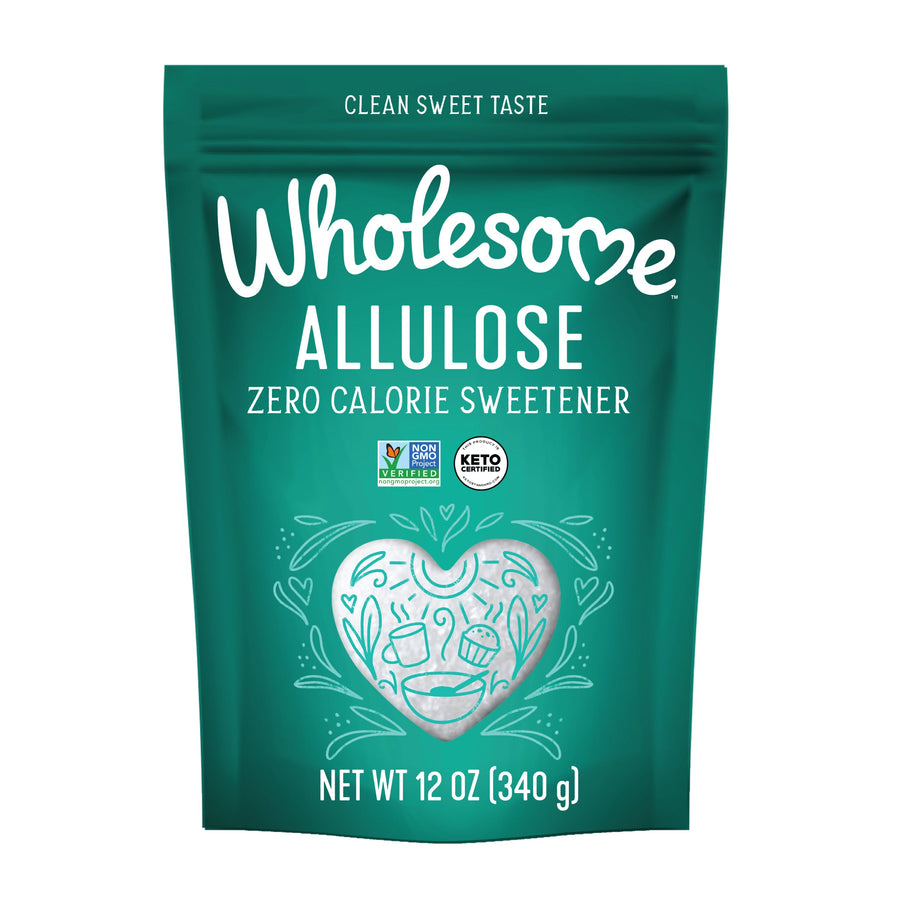 A teal pouch labeled "Wholesome Allulose" features the text "Zero Calorie Sweetener," decorative heart and leaf designs, and certification logos for Non-GMO and Keto, indicating a clean sweet taste product.