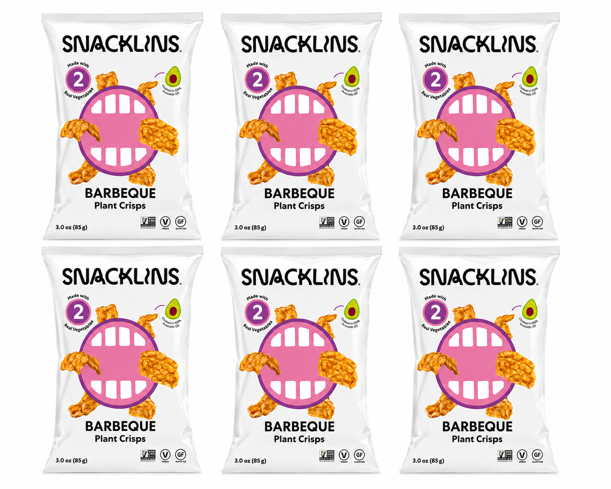 Six bags of Snacklins Barbeque Plant Crisps are arranged in two rows, each featuring a playful design with a pink circle and cartoon mouth, emphasizing the product's plant-based ingredients.