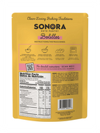 A yellow packaging for Sonora Keto Pantry Bolillos features baking instructions, nutrition facts, and ingredient list, highlighting its keto-friendly nature for making traditional bolillos.
