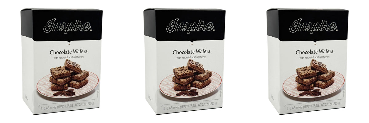 Three boxes of Inspire Chocolate Wafers are displayed, each featuring a stack of chocolate wafers on a decorative plate, emphasizing the product's natural and artificial flavors.