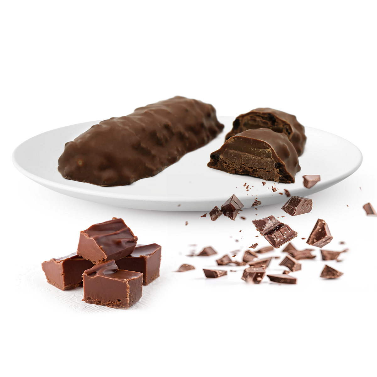 A chocolate-covered snack bar is displayed on a white plate, with one bar cut in half revealing its filling, alongside pieces of chocolate and chocolate shavings on a white background.
