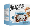 A box of Inspire Protein Kitchen Chocolate Peanut Butter high protein cereal features a bowl filled with cereal and a spoon, showcasing ingredients like peanuts and chocolate on the side.