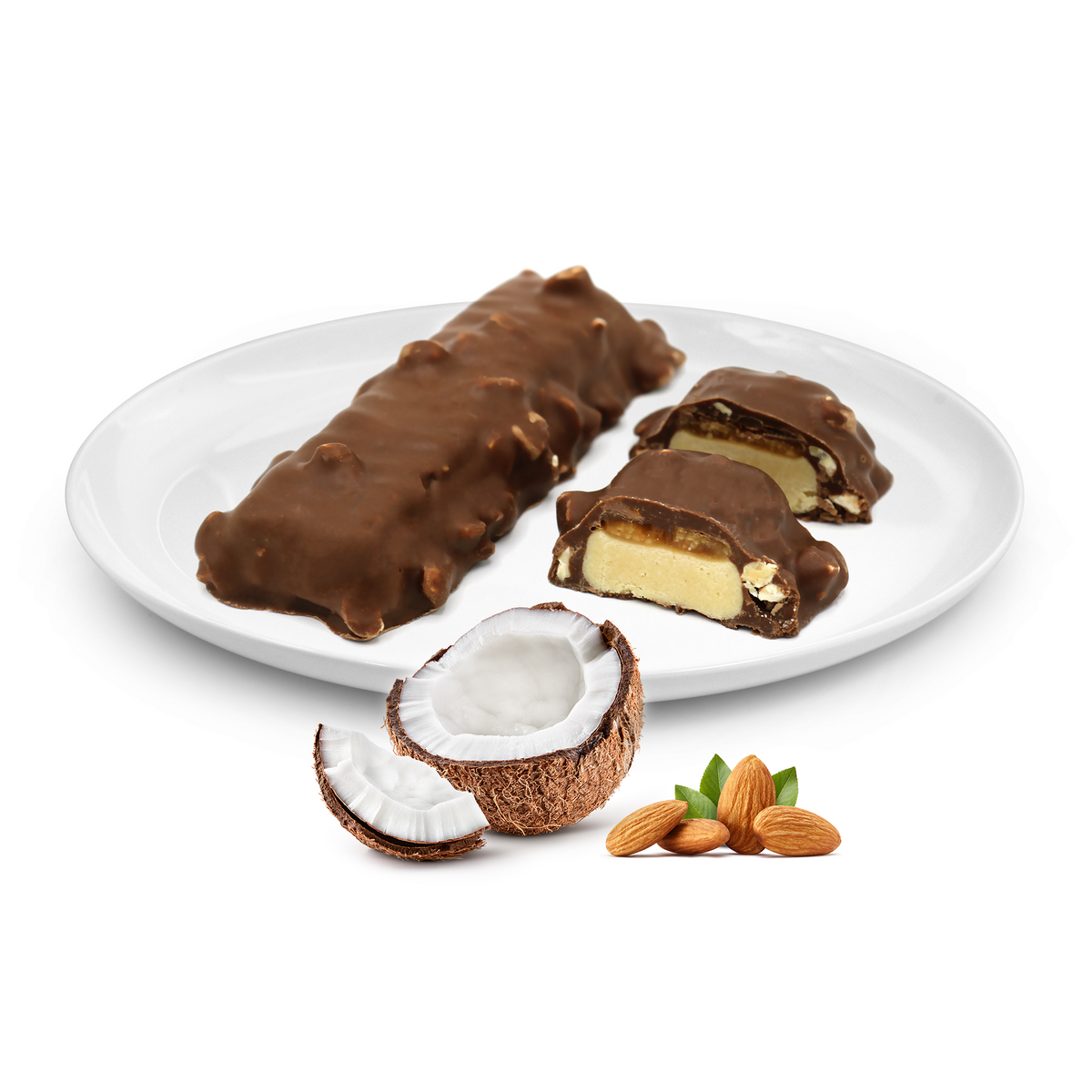 A white plate holds a chocolate-covered protein bar and two cut pieces revealing a creamy filling, accompanied by a halved coconut and scattered almonds.
