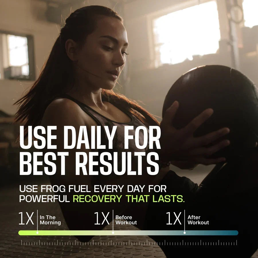 A woman in athletic wear focuses on holding a medicine ball in a well-lit gym, promoting daily use of Frog Fuel for effective recovery before and after workouts.