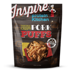 A bag of Inspire brand Original Crispy Pork Puffs displays a colorful design with a chef illustration, featuring the product name prominently and a serving of pork puffs on a plate.