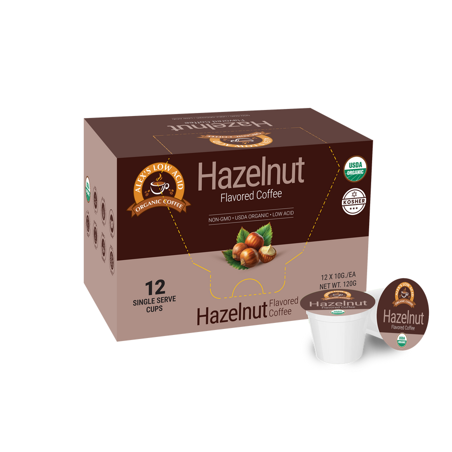 A brown box of organic hazelnut flavored coffee with a logo and information about its low acidity, containing 12 single-serve cups, is displayed against a plain background.