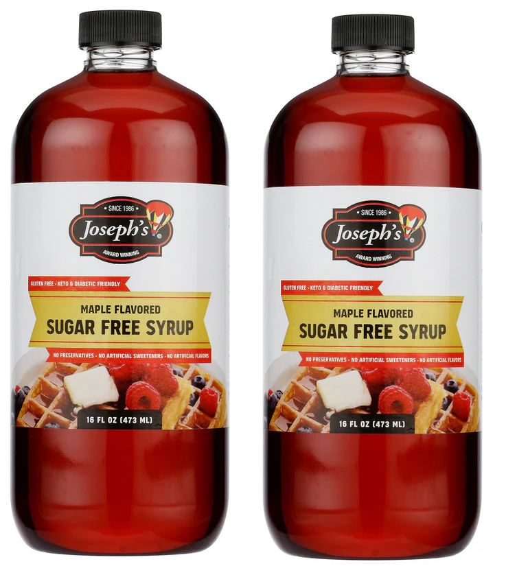 Two bottles of Joseph's maple-flavored sugar-free syrup are displayed side by side, each labeled as gluten-free, keto, and diabetic-friendly, with a serving suggestion of waffles topped with berries and butter.