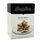 A box of Inspire Mocha Wafers sits beside a plate with stacked wafers drizzled with chocolate, showcasing the product's flavors and packaging details.