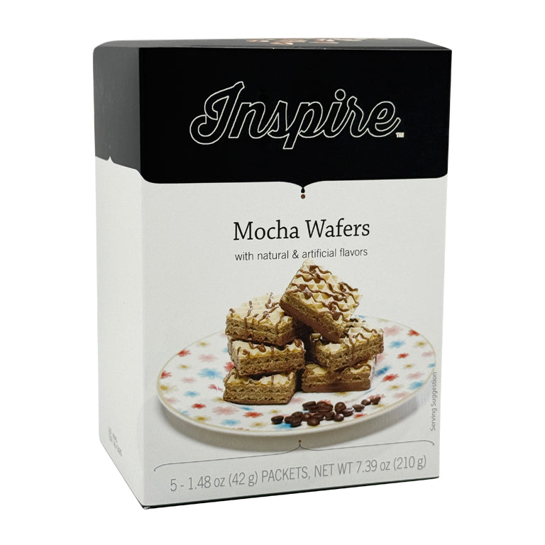 A box of Inspire Mocha Wafers sits beside a plate with stacked wafers drizzled with chocolate, showcasing the product's flavors and packaging details.