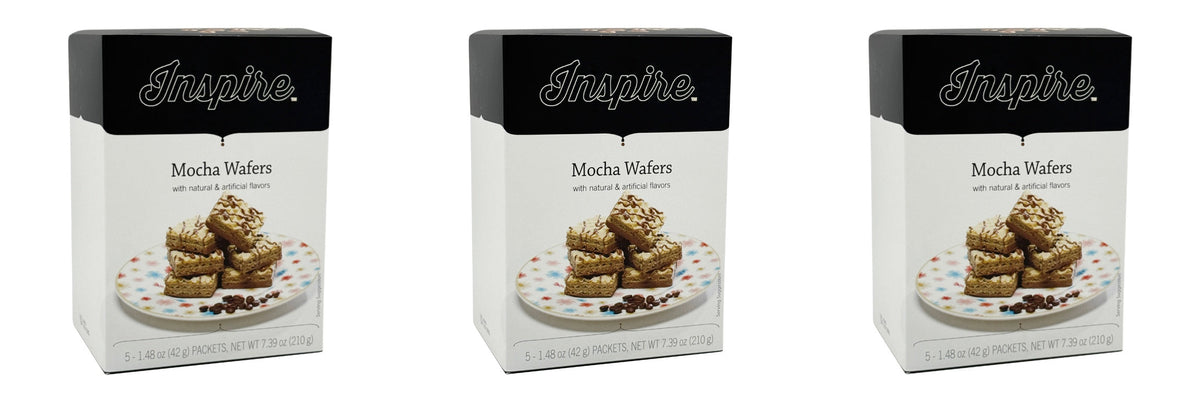 Three boxes of Inspire Mocha Wafers are displayed, each featuring a stack of layered wafers topped with cream and coffee beans on a colorful plate, highlighting the product's flavors and packaging design.