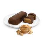 Chocolate-covered peanut butter bars are displayed on a white plate, with one bar cut in half to reveal the creamy filling, accompanied by a bowl of smooth peanut butter and whole peanuts.