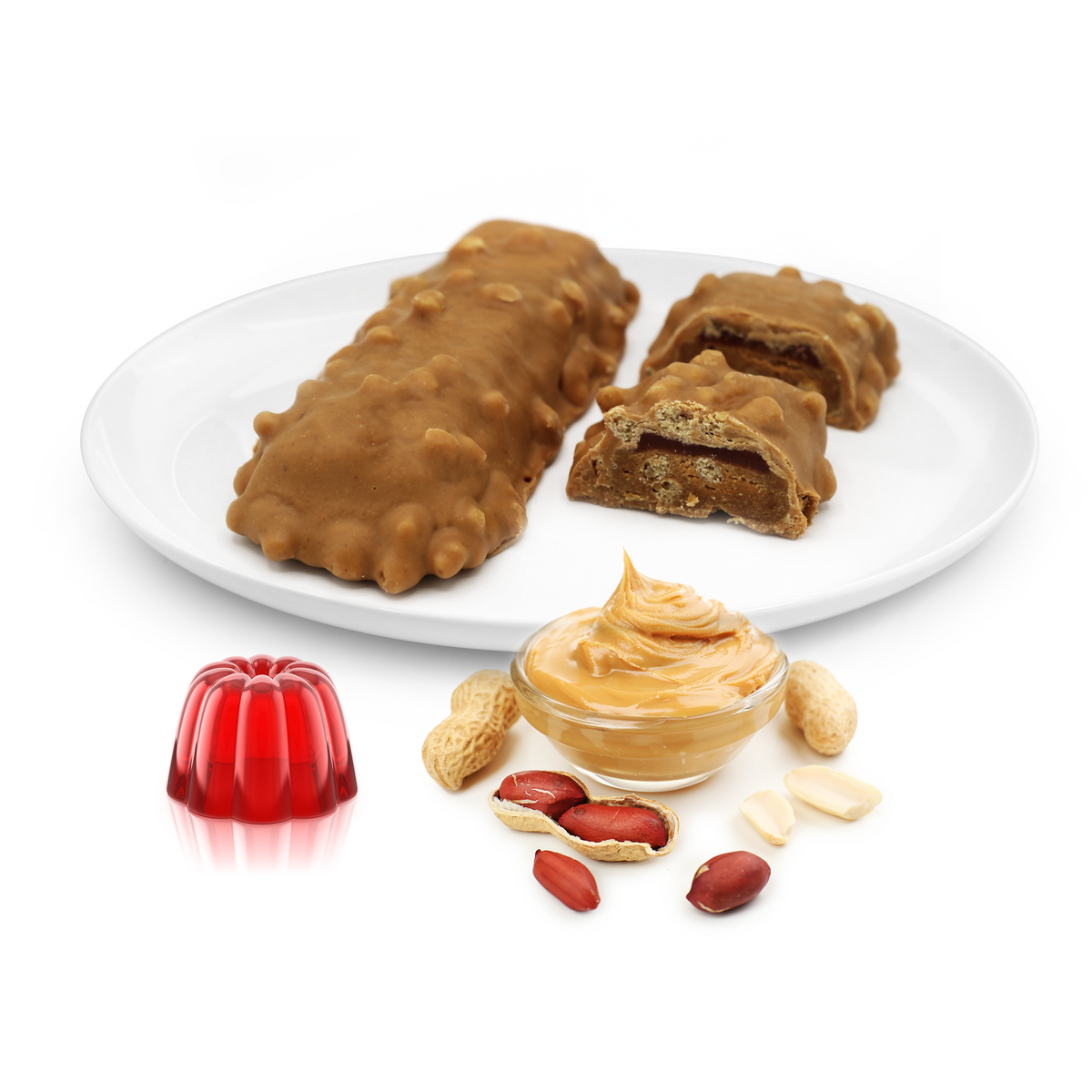 Peanut butter protein bars coated in a caramel-like layer, displayed on a plate with a dollop of peanut butter, peanuts, and a red gelatin dessert.
