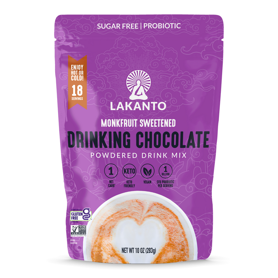 A purple package of Lakanto Monkfruit Sweetened Drinking Chocolate powder features the product name prominently, highlighting it's sugar-free, keto-friendly, and vegan, with 18 servings per bag.