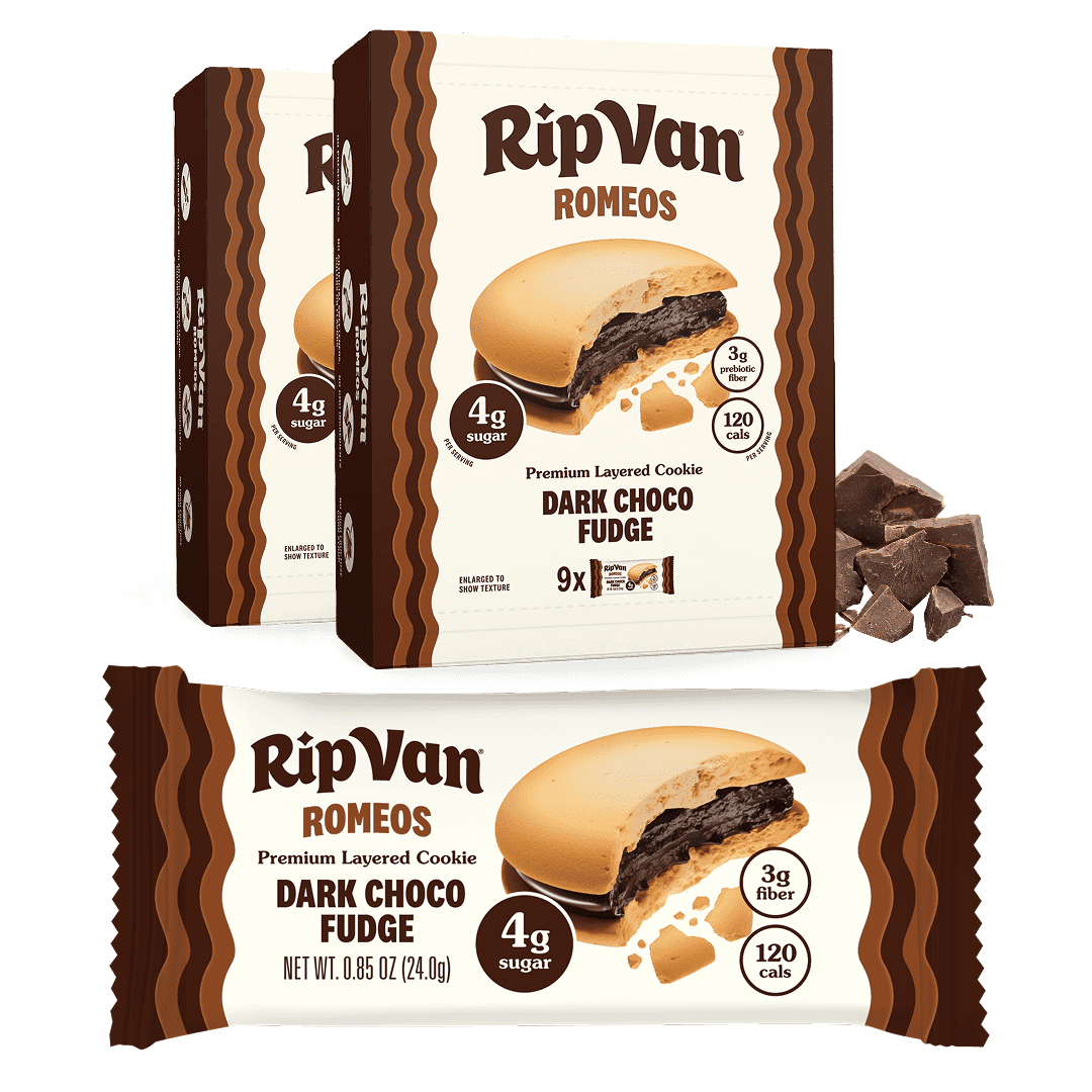 Two boxes of RipVan Romeo cookies labeled "Dark Choco Fudge" are displayed, with one cookie partially broken to show its layered filling, alongside pieces of dark chocolate.