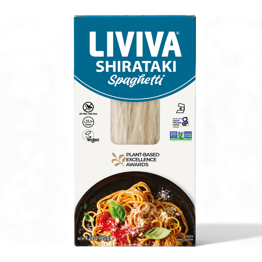 A blue and white package of LIVIVA Shirataki Spaghetti displays the product name prominently, with a photo of cooked spaghetti topped with sauce and basil on a black plate.