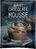 A package of Sukrin chocolate mousse is displayed, featuring a glass dessert topped with blueberries and chocolate shavings, with a label indicating "No added sugar" and serving details.