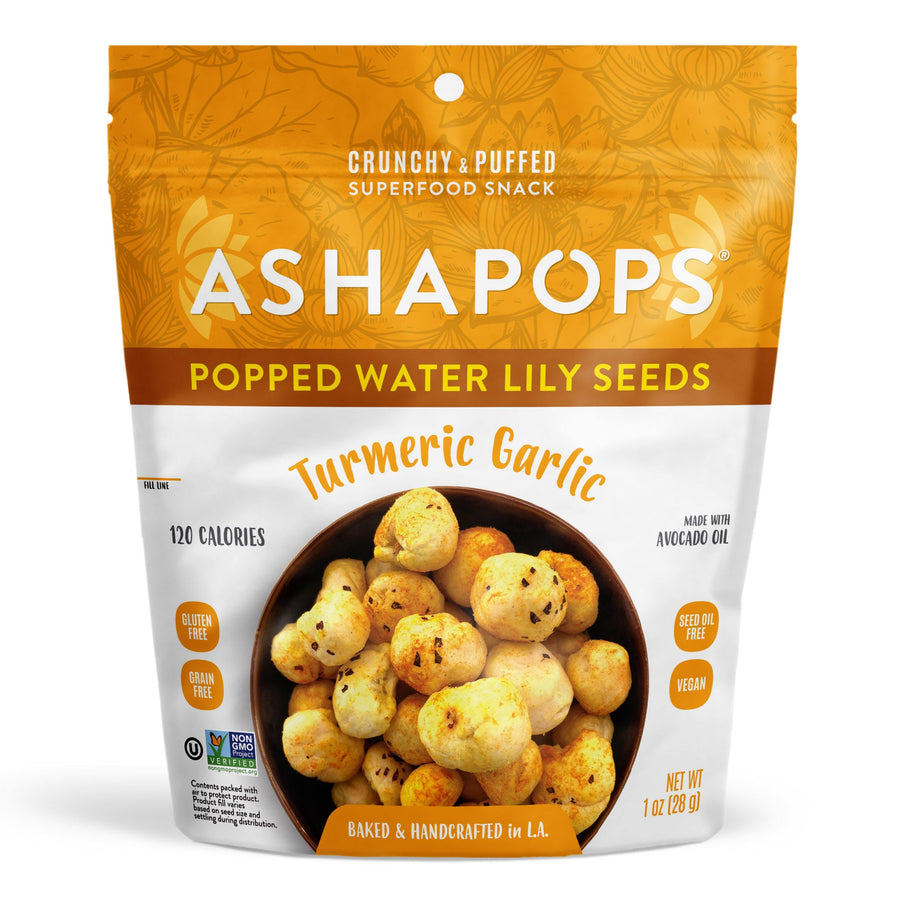 A bag of Asha Pops Popped Water Lily Seeds in Turmeric Garlic flavor, featuring a bowl of crunchy snacks, labeled as gluten-free, vegan, and handcrafted, with a bright orange and white design.