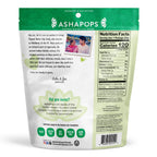 A green package of Ashapops popped water lily seeds features a photo of a mother and son, along with nutritional information and a note about the product's Indian heritage and health benefits.
