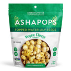 A green and white snack bag labeled "ASHAPOPS" contains popped water lily seeds, showcasing a bowl of crunchy, vegan cheese-flavored snacks with nutritional information and dietary labels.