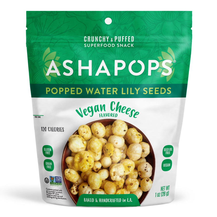 A green and white snack bag labeled "ASHAPOPS" contains popped water lily seeds, showcasing a bowl of crunchy, vegan cheese-flavored snacks with nutritional information and dietary labels.