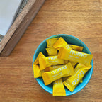 Numa Banana Cream wrapped taffies in a blue bowl