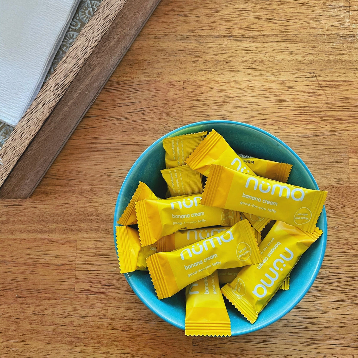 Numa Banana Cream wrapped taffies in a blue bowl