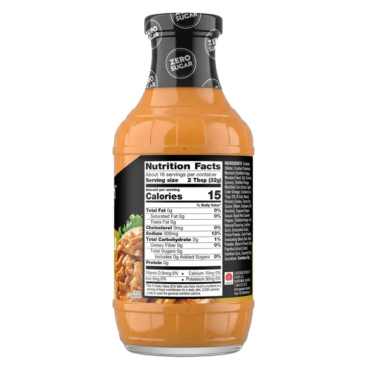 A clear bottle of zero sugar sauce displays nutrition facts and ingredients, with a focus on low calories and no added sugars, set against a plain background.