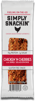 A snack package for Simply Snackin' Chicken 'n Cherries with BBQ seasoning, featuring a textured meat bar, nutritional information, and a gluten-free label, set against a white background.