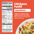 A colorful plate of chickpea fusilli pasta mixed with vegetables sits beside a nutrition facts label detailing ingredients and serving information, highlighting organic chickpea and brown rice flour.