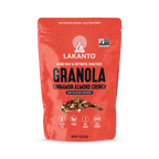 A bright red bag of Lakanto Cinnamon Almond Crunch granola features bold text highlighting it is gluten-free, vegan, and sweetened with monk fruit and erythritol, with no added sugar.