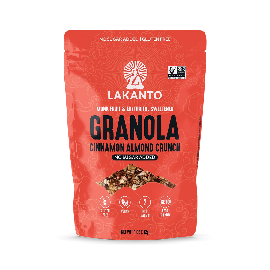 A bright red bag of Lakanto Cinnamon Almond Crunch granola features bold text highlighting it is gluten-free, vegan, and sweetened with monk fruit and erythritol, with no added sugar.